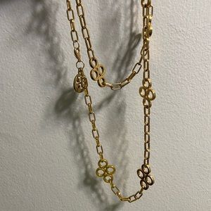 Long gold Tory Burch necklace. Never worn. Excellent condition.
